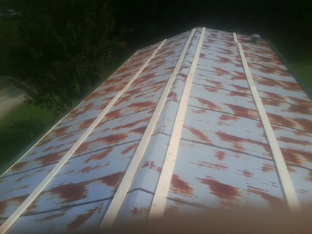 Rusted metal roof panels with new wood purlins before replacement — Storm Damage Roof Repair in Fort Rock by Roofing Brothers
