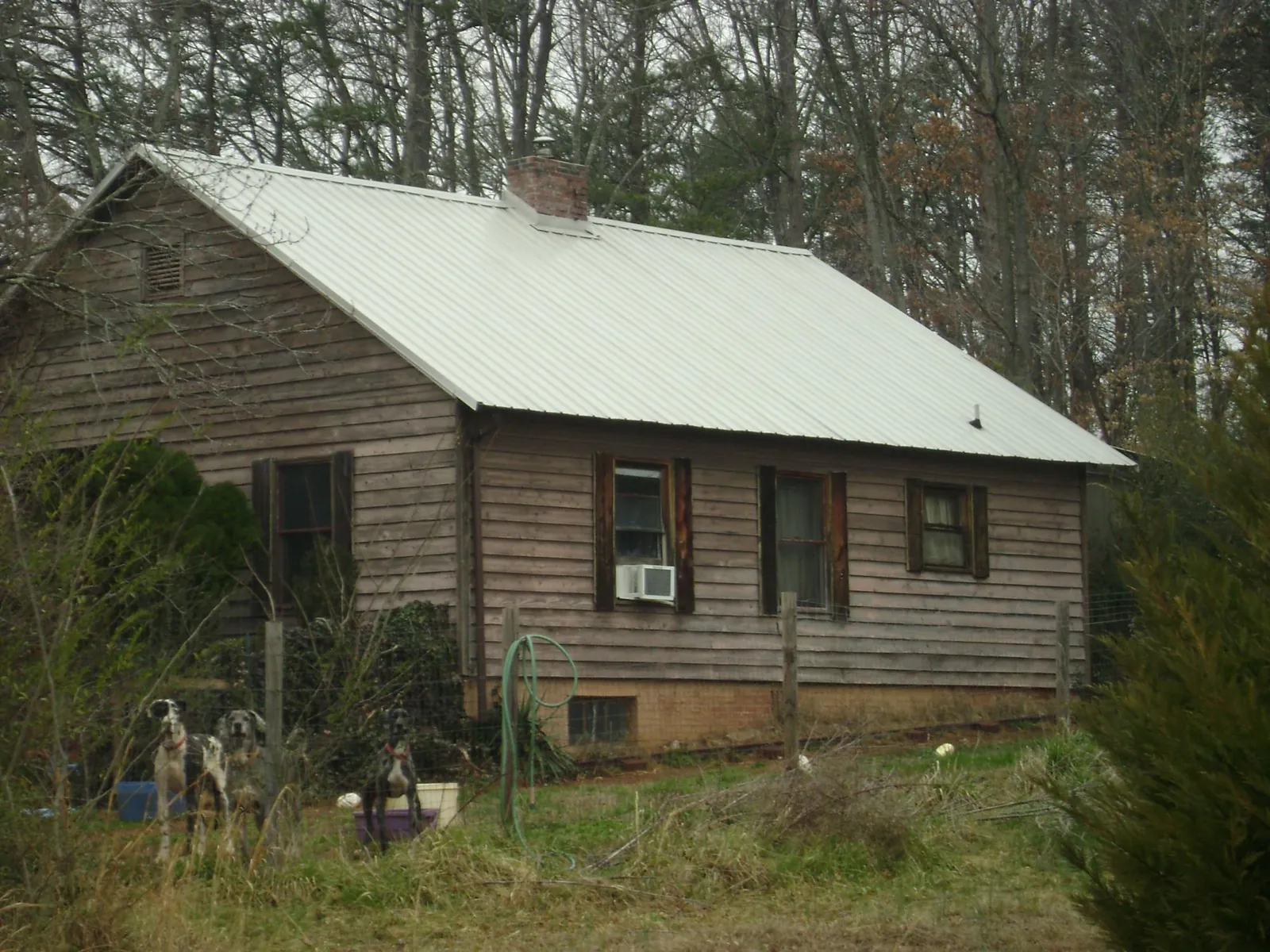White metal roof on an old wood sided farmhouse, from a Metal Roof Installation job in Fort Rock